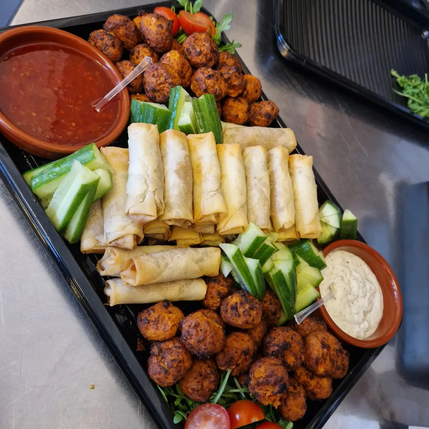 Sandwiches, savoury bites and dips arranged on a Slice platter