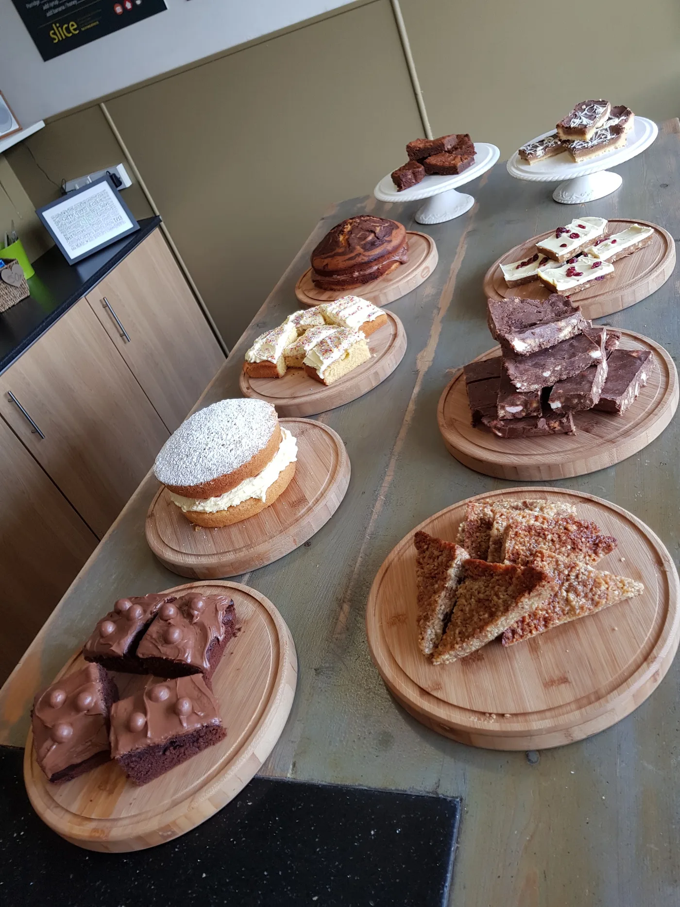 A selection of homemade cakes on stands inside Slice